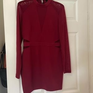 Red dress, sheer on arms and small area of chest. Cut outs around waist